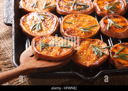 Arrosto di patate dolci su una padella per grigliare macro sul tavolo orizzontale. Foto Stock