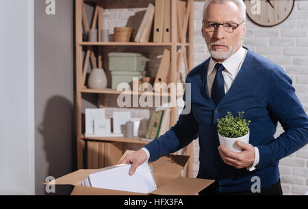 Triste respinto lavoratore di ufficio mettendo via le sue cose Foto Stock