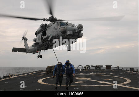 111101-N-XQ375-511 Mar Arabico (nov. 1, 2011) BoatswainÕs Mate marinaio apprendista Jonathan Richardson, sinistra e BoatswainÕs Mate marinaio apprendista C.L. Barnes Jr. cancella il ponte di volo delle visite-missile destroyer USS Mitscher (DDG 57) durante un rifornimento verticale. Mitscher è distribuito negli Stati Uniti Quinta Flotta area di responsabilità condurre le operazioni di sicurezza marittima e di protezione del teatro gli sforzi di cooperazione. (U.S. Foto di Marina di Massa lo specialista di comunicazione di terza classe Deven B. King/RILASCIATO) Navy US 111101-N-XQ375-511 marinai attaccare un carico netto per un MH-60R Sea Hawk elicottero Foto Stock