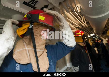 120130-N-PB383-002 GOLFO ARABICO (GEN. 30, 2012) Engineman Fireman apprendista Sean Grotta dons le attrezzature antincendio durante un totale nave esercizio di resilienza a bordo il trasporto anfibio dock nave USS New Orleans (LPD 18). New Orleans e avviato Marines assegnato all'undicesimo Marine Expeditionary Unit (XI MEU) vengono distribuite come parte di Makin Island pronta anfibio che sostiene le operazioni di sicurezza marittima e di teatro la cooperazione in materia di sicurezza gli sforzi negli Stati Uniti Quinta Flotta area di responsabilità. (U.S. Foto di Marina di Massa lo specialista di comunicazione 2a classe Dominique Pineiro/RILASCIATO) US Foto Stock