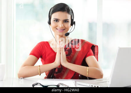 Indian imprenditrice che indossa la cuffia e sorridente Foto Stock