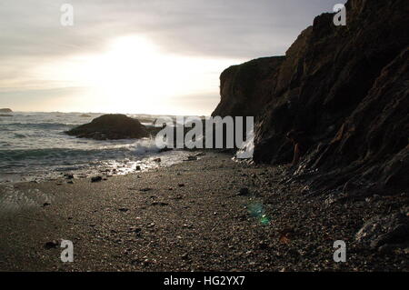 Un'onda si blocca sulla riva durante il tramonto in Fort Bragg, CA Foto Stock