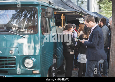 Londra pausa pranzo al di fuori il Gherkin. Attesa di persone in fila per la strada diverse bancarelle prodotti alimentari Foto Stock