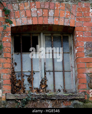 Finestra sbarrata in un edificio rurale Foto Stock