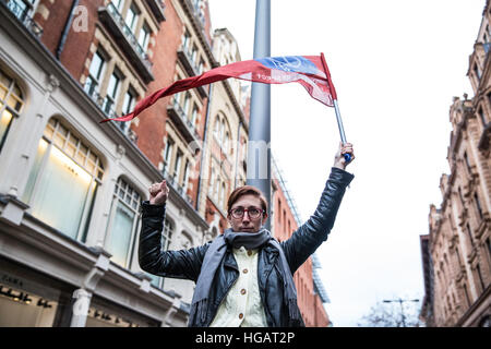 Londra, Regno Unito. Il 7 gennaio, 2017. Un sostenitore del Regno voci del commercio mondiale unione detiene il sindacato la bandiera a una protesta al di fuori di Harrods contro il negozio di ritenzione fino a 75% del 12,5% di tassa di servizio aggiunto per le fatture di diners nei suoi ristoranti di lusso. Credito: Mark Kerrison/Alamy Live News Foto Stock