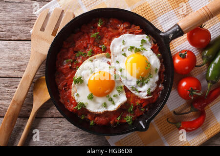 Huevos rancheros closeup in padella e gli ingredienti sul tavolo orizzontale, vista da sopra Foto Stock