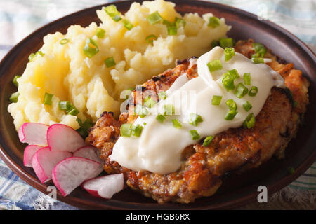 Chicken fried steak e sugo bianco con purè di patate su una piastra di close-up orizzontale Foto Stock