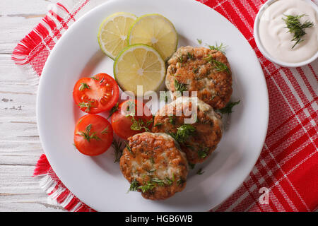 Hot torte di pesce con salsa di aneto sul tavolo di close-up. vista orizzontale dal di sopra Foto Stock