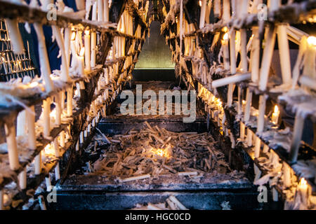 Offerte di candele in pellegrinaggio del Rocio. Le candele accese sul ripiano Foto Stock