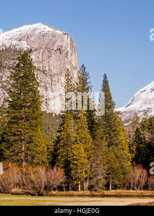 Il parco nazionale di Yosemite Valley - mezza cupola si erge maestosamente sopra gli alberi sul fondovalle su una luminosa giornata invernale e nel dicembre 2016. Foto Stock