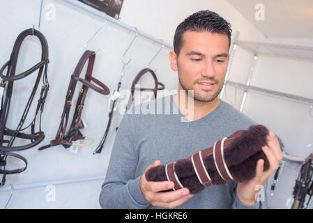 Uomo in negozio equestre Foto Stock