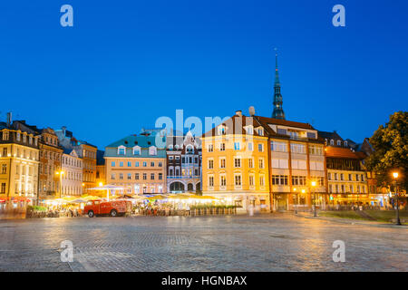 Riga, Lettonia - 1 Luglio 2016: Vista di antichi edifici architettonici della città vecchia in Piazza Duomo in brillante illuminazione serale, popolare spettacolo turistico Foto Stock