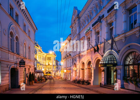 Vilnius, Lituania - 8 Luglio 2016: vista laterale della facciata di Europa Royale Hotel edificio su via Ausros Vartu nella luminosa illuminazione serale, famoso L Foto Stock