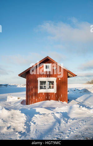 Piccola casetta nella neve in inverno. Fagelsundet villaggio di pescatori sulla costa di Roslagen, Uppland, Svezia e Scandinavia Foto Stock