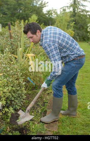 Giardiniere confine di scavo Foto Stock