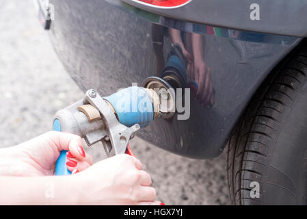 Auto alla stazione di gas essendo riempito con carburante Foto Stock