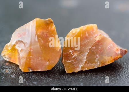 Due materie e non tagliato pezzi di caramello marrone opali africani in ghisa nera. Foto Stock