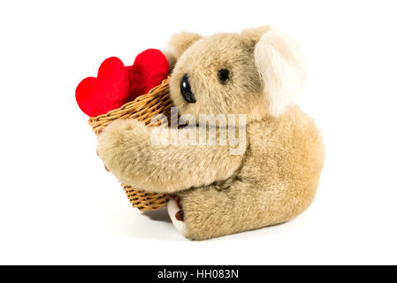 Orsacchiotto di peluche che trasportano il bambù cesto pieno di cuore per il giorno di san valentino Foto Stock