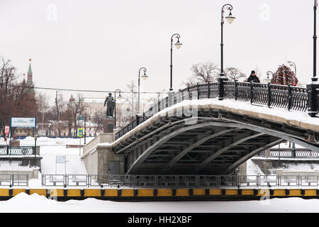 Mosca, Russia. Domenica, 15 gennaio 2017. Luzhkov (noto anche come amante di) ponte sopra il canale di bypass sul fiume di Mosca. Gli alberi di ferro con lucchetti di nozze. No matrimoni oggi. Ilya Repin - famoso pittore russo un monumento in background. Wet, ventoso e nevoso domenica a Mosca. La temperatura è di circa -2C (28F). Nuvole pesanti, bufera di neve. Pulitori per strada e la pulizia della neve veicoli sono occupato. © Alex Immagini/Alamy Live News Foto Stock