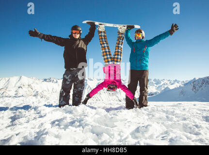 Gruppo amici amanti dello snowboard divertirsi sul pendio Foto Stock