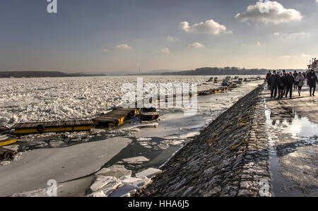 Belgrado, Serbia - Walkers passando dai ghiacci galleggianti e barche del Danubio a Zemun Foto Stock