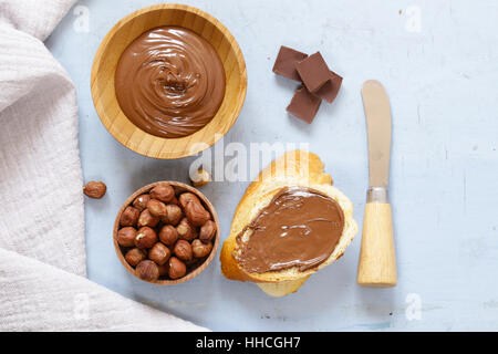 Pasta cioccolato distribuito con le nocciole e il pane per la colazione Foto Stock