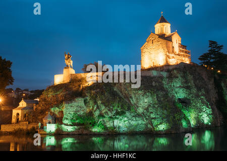 Notte illuminata di sera vista della Chiesa di Metekhi e la statua equestre del re Vakhtang Gorgasali sulla scogliera di Metekhi nel vecchio e storico Distric Foto Stock