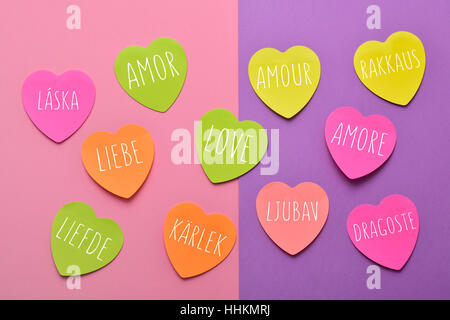 Alcuni a forma di cuore note adesive di diversi colori con la parola amore scritte in lingue diverse, come spagnolo, portoghese, italiano, francese, Po Foto Stock