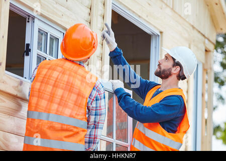 Finestra di due cooperanti montatore e finestra di installazione per la nuova casa Foto Stock