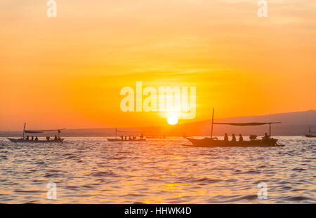 Sunrise, canoe outrigger in mare, Lovina Beach, Bali, Indonesia Foto Stock