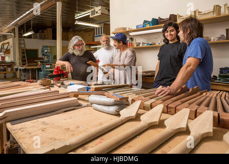 Guitar maker in laboratorio controllo qualità colli di chitarra Foto Stock