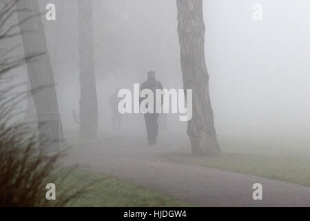 Chippenham, Regno Unito. 25 gennaio 2017. Clima invernale nebbioso nel Regno Unito. Mentre la nebbia ricopre molte parti del Regno Unito, le persone sono ritratte a camminare in un parco a Chippenham, Wiltshire. Crediti: Lynchpics/Alamy Live News Foto Stock