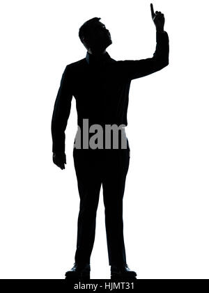 Un caucasian business man poiting fino felice silhouette permanente di lunghezza completa in studio isolato su sfondo bianco Foto Stock