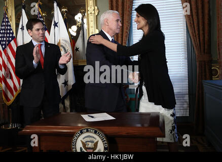 Washington DC, Stati Uniti d'America. Il 25 gennaio 2017. Il Vicepresidente degli Stati Uniti Mike pence (C) si congratula con Nikki Haley alla fine della cerimonia dove lei ha prestato giuramento come NEGLI STATI UNITI Ambasciatore presso le Nazioni Unite, Gennaio 25, 2017 a Washington, DC. Haley era precedentemente noto come il governatore della Carolina del Sud. Inoltre è raffigurato a noi il senatore Marco Rubio (repubblicano della Florida). Credito: vittoria McNamee/Piscina via CNP /MediaPunch/Alamy Live News Foto Stock