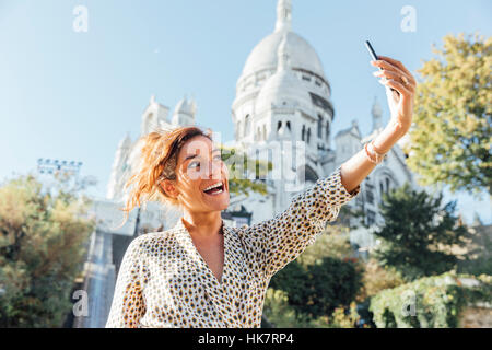 Parigi, Donna visitando e facendo un selfie a Montmartre Foto Stock