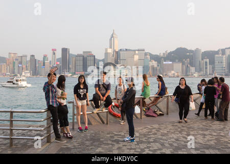 Hong Kong, Hong Kong - 26 Aprile 2015: turisti scattare foto e gustare la famosa isola di Hong Kong skyline su Victoria Harbour dalla avenue di Foto Stock