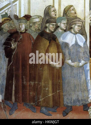 Questo dipinto dettagliato di Giotto di Bondone raffigura l'istituzione del presepe a Greccio, parte della *leggenda di San Francesco*. L'uso di colori vivaci e figure espressive di Giotto cattura il momento sacro in cui San Francesco creò il primo presepe nel 1223. Foto Stock
