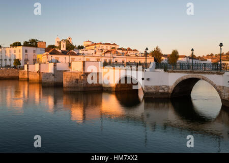 Sette arcate del ponte romano e la città sul Rio fiume Gilao presso sunrise, Tavira, Algarve, Portogallo, Europa Foto Stock