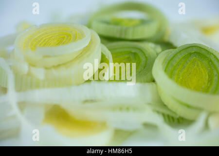 I porri tagliati a fettine sottili anelli su una piastra bianca ad essere utilizzato per un ingrediente Foto Stock