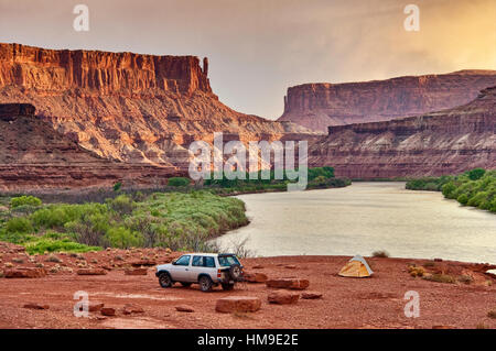 Veicolo 4x4 al campeggio nel Labirynth Canyon con Bighorn Mesa su Green River, White Rim Road, Canyonlands National Park, Utah, USA Foto Stock