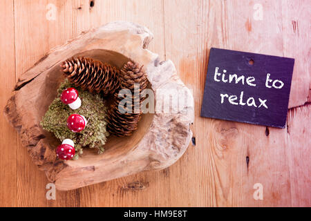 Pigne nelle quali sul tavolo di legno e lavagna con le parole il tempo per rilassarsi Foto Stock