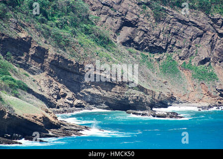 Le onde del mare di colpire grandi rocce di pietra sulla giornata di sole Foto Stock