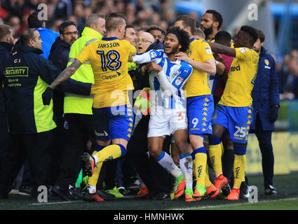 Modera flare come Huddersfield Town Isaia marrone (centro) e Leeds United's Pontus Jansson (sinistra) si confrontano tra loro durante il cielo di scommessa match del campionato a John Smith's Stadium, Huddersfield. Foto Stock