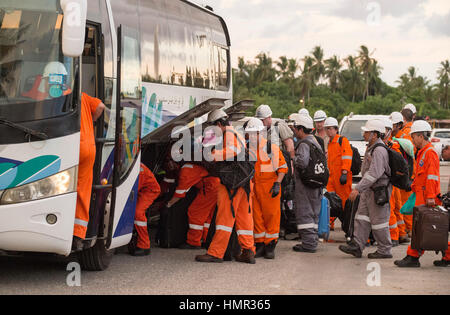 I lavoratori petroliferi in tute arancioni sono visti dopo il loro trasferimento dalle piattaforme offshore di perforazione petrolifera tramite navi di supporto al porto vicino a Kuala Belait. © Time-Snap Foto Stock