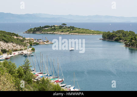 La piccola isola di Panayia in corrispondenza della bocca di porto di Gaios, Paxos Grecia, con la terraferma greca della distanza Foto Stock