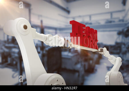 Immagine in computer grafica di mano robotica azienda il lavoro di squadra contro il testo immagine sfocati di macchinari Foto Stock