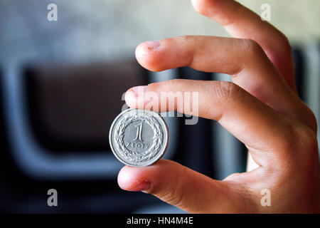 Coin in una mano, il denaro di Polonia, Polish zloty, sfondo Foto Stock