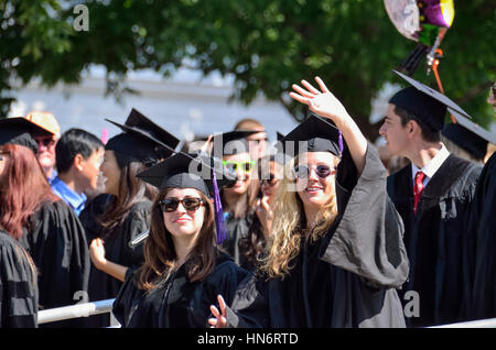 Charlottesville, Stati Uniti d'America - 18 Maggio 2014: Ragazze sventolare alla cerimonia di laurea in abiti presso la University of Virginia Foto Stock