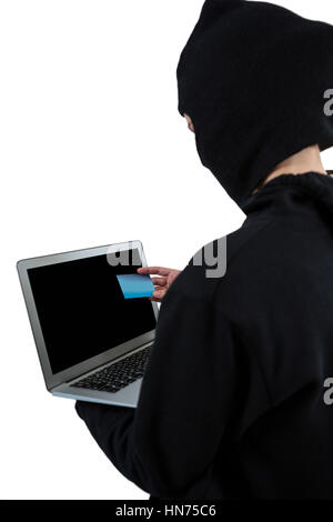 Hacker utilizzando laptop e la carta di credito su sfondo bianco Foto Stock