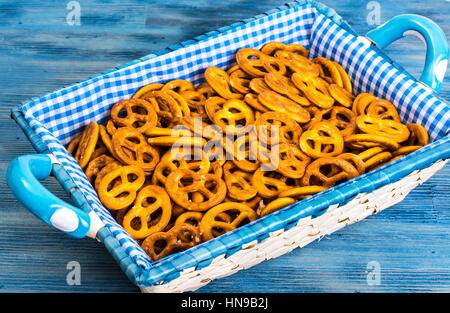 Bianco cesto in vimini del pane con un panno a scacchi sul backgr blu Foto Stock